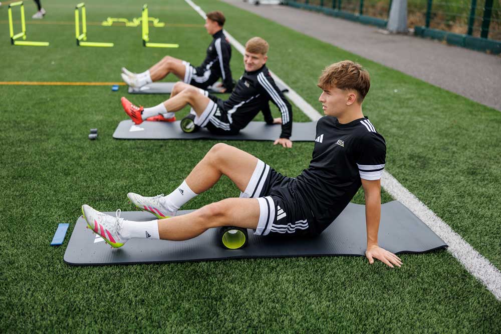 Fletcher Boyd and other professional footballers warming up before their training session